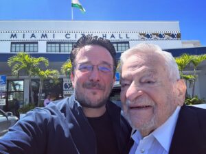 Billy Corben Instagram - Two Florida Men walk into City Hall…

Went with my grandpa — Miami-Dade resident since 1946, University of Miami School of Law c/o 1951 — to speak at the commission meeting today and do our best to fix this mess. The mango doesn’t fall far from the tree. Video coming soon… #BecauseMiami