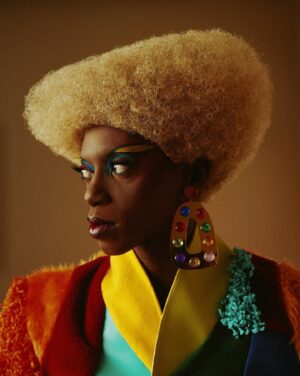 Black Peppa Instagram - BTS shots before heading to @frolovheart SHOW. Thank you @thelondoner 💖

LFW- LOOK 4- Wearing custom @christopherniari to attend the @frolovheart SHOW. Had this concepts for months where I’d use various fabrics with different textures particularly bathroom rugs, felt, suede, faux leathers and furs to create a groovy tailored high waisted pants suit. For this LFW it was also my priority to showcase more black hair styles and desired to style a blonde Afro myself. This was the first time I’ve styled any wig and was quite proud of the end result I must say.

Photographer: @kimlangstudio 
MUA: @jackoliverx using @theunseenbeauty 
Full look: @christopherniari 
Hair by me
Earrings: @nobasicbombshell
Money Nails by @nailsanthonys