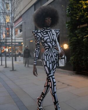 Black Peppa Instagram - London Fashion Week Look 1 - Part 1
LCF POSTGRADUATE SHOW 🦓

📸 @ivantruewizard 
MUA: @jackoliverx 
Catsuit constructed by @itsjust_joe and fully hand painted by moi 
Waist: corset by @misty_couture 
Heels: @hummingbirdheels spray painted and painted by me including handbag bought from a charity shop.

Makeup
@trixiecosmetics Hotline gel liner white on eyelids
Foundation: @kvdbeauty 
Setting powder and spray : @onesize 
@weledauk 
@maccosmeticsuk