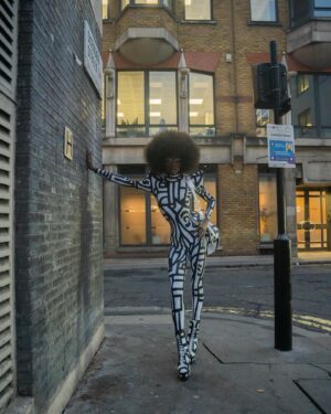 Black Peppa Instagram - London Fashion Week Look 1 - Part 1
LCF POSTGRADUATE SHOW 🦓

📸 @ivantruewizard 
MUA: @jackoliverx 
Catsuit constructed by @itsjust_joe and fully hand painted by moi 
Waist: corset by @misty_couture 
Heels: @hummingbirdheels spray painted and painted by me including handbag bought from a charity shop.

Makeup
@trixiecosmetics Hotline gel liner white on eyelids
Foundation: @kvdbeauty 
Setting powder and spray : @onesize 
@weledauk 
@maccosmeticsuk