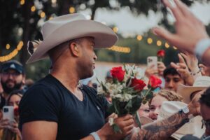 Coffey Anderson Instagram - Every rose has a story, just like every one of us.⁠

My home’s landscaping was designed with rose bushes in the front entrance and back wall by my wife. She got them planted in memory of my sweet mother, Gloria Jean. Her favorite flower was a rose. When they bloom, I think of her often. 🥹 
⁠
During my performances of "Better Today," I usually share roses with the crowd - a small gesture, symbolizing love, appreciation, and the beauty of each moment we're together.⁠
⁠
A rose is more than just a flower. It's a symbol of love and respect, and a reminder that even the simplest acts can touch the heart deeply. I believe in spreading love and positivity one rose at a time, making every day a little better.⁠
⁠
To all the beautiful souls out there, remember that your small gestures of kindness can make a big impact on someone's life. Let's keep sharing love, in every way we can. ⁠
⁠
If you read to the bottom of this caption drop a 🌹 in the comments!⁠
⁠
#BetterToday #ShareTheLove #Roses #LiveMusic #CountryMusic #CountryEverAfter #Country #Concert