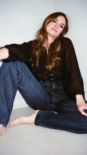 Danielle Panabaker Instagram - I’ve had this @shopdoen top for years, and it’s still a favorite. Trying out a little bit of a 70s-inspired look today with these flared @goodamerican jeans and aviators. I think I could have thrived in that era.