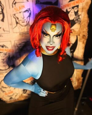 Dax ExclamationPoint Instagram - After finally getting home and sleeping HARD in my own bed, I wanted to thank @homosuperior_pdx again❣️ (especially for this photo backdrop that literally everyone at the event wanted to take home) 

And of course thanks to @ardawigs  for providing my hair, @3dinfinitydc for all my mystique skulls, and @indibeat_cosmetics for their full coverage #facebass foundation. 

I used a combination of their blue, white, and a green color correcting primer I had in my kit to shade match a zentai (so I wouldn’t be forced to do body paint.) 

Anyway thanks for a great night! It’s always a good time with @dmandamartini @sinagrace and @terryblas ❣️❣️❣️❣️ #xmen #homoSuperior #hausDarkholm #mystique #valCooper #drag #portland #comix