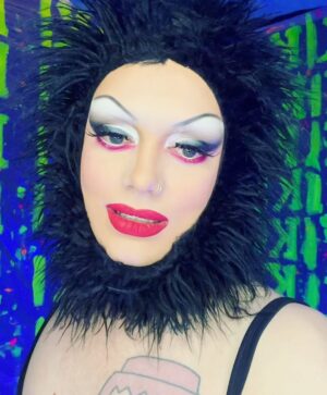 Dimitri Nana-Côté Instagram - LOTS of fun at @rendezvousdeladrag this weekend💕🌟 The first Quebec/Francophone drag convention went amazing!!

Thanks to everyone who came to my neon/paint booth and bought some merch!!🎨 

It was a challenge to make the neon/blue light effect functional!
Lots of paint, finding a way to isolate the ambient light, and picking outfits and makeups that would react differently under the light in my booth VS when I would walk around the convention center💡

Thanks to @thatboyfromthehub and @edward_jpeg for helping me set up my booth 💪🏾 & big merci to @theonlyrjjb for assisting me on day 1💛

Red/pink dress from my CDR1 package by @_thesukidoll & yellow outfit base from @gisele_lullaby 👗💃