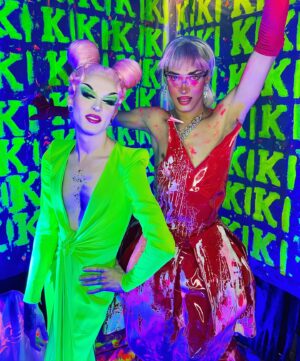 Dimitri Nana-Côté Instagram - LOTS of fun at @rendezvousdeladrag this weekend💕🌟 The first Quebec/Francophone drag convention went amazing!!

Thanks to everyone who came to my neon/paint booth and bought some merch!!🎨 

It was a challenge to make the neon/blue light effect functional!
Lots of paint, finding a way to isolate the ambient light, and picking outfits and makeups that would react differently under the light in my booth VS when I would walk around the convention center💡

Thanks to @thatboyfromthehub and @edward_jpeg for helping me set up my booth 💪🏾 & big merci to @theonlyrjjb for assisting me on day 1💛

Red/pink dress from my CDR1 package by @_thesukidoll & yellow outfit base from @gisele_lullaby 👗💃