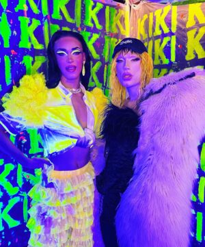 Dimitri Nana-Côté Instagram - LOTS of fun at @rendezvousdeladrag this weekend💕🌟 The first Quebec/Francophone drag convention went amazing!!

Thanks to everyone who came to my neon/paint booth and bought some merch!!🎨 

It was a challenge to make the neon/blue light effect functional!
Lots of paint, finding a way to isolate the ambient light, and picking outfits and makeups that would react differently under the light in my booth VS when I would walk around the convention center💡

Thanks to @thatboyfromthehub and @edward_jpeg for helping me set up my booth 💪🏾 & big merci to @theonlyrjjb for assisting me on day 1💛

Red/pink dress from my CDR1 package by @_thesukidoll & yellow outfit base from @gisele_lullaby 👗💃