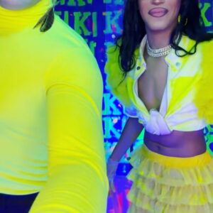 Dimitri Nana-Côté Instagram - LOTS of fun at @rendezvousdeladrag this weekend💕🌟 The first Quebec/Francophone drag convention went amazing!!

Thanks to everyone who came to my neon/paint booth and bought some merch!!🎨 

It was a challenge to make the neon/blue light effect functional!
Lots of paint, finding a way to isolate the ambient light, and picking outfits and makeups that would react differently under the light in my booth VS when I would walk around the convention center💡

Thanks to @thatboyfromthehub and @edward_jpeg for helping me set up my booth 💪🏾 & big merci to @theonlyrjjb for assisting me on day 1💛

Red/pink dress from my CDR1 package by @_thesukidoll & yellow outfit base from @gisele_lullaby 👗💃
