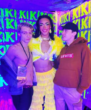 Dimitri Nana-Côté Instagram - LOTS of fun at @rendezvousdeladrag this weekend💕🌟 The first Quebec/Francophone drag convention went amazing!!

Thanks to everyone who came to my neon/paint booth and bought some merch!!🎨 

It was a challenge to make the neon/blue light effect functional!
Lots of paint, finding a way to isolate the ambient light, and picking outfits and makeups that would react differently under the light in my booth VS when I would walk around the convention center💡

Thanks to @thatboyfromthehub and @edward_jpeg for helping me set up my booth 💪🏾 & big merci to @theonlyrjjb for assisting me on day 1💛

Red/pink dress from my CDR1 package by @_thesukidoll & yellow outfit base from @gisele_lullaby 👗💃
