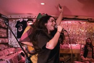E. R. Fightmaster Instagram - This year my band FIGHTMASTER threw a holiday show in support of Alexandria House. Thank you to our incredible guests @carolinerosemuzak @goldsoundz_ @brideymusic and @alexisgfloyd for bringing the house down, and for our incredible audience for bringing the joy. May your holidays be gay and your New Year even gayer. 
Special thanks to Morgan if Ye Merry Merch Table, to @taliahart always, to @permanentrecordsroadhouse for housing us and to @dubinphoto for capturing the moment ❤️ @alexandriahousela ❤️