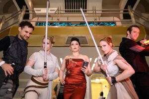 Erika Ishii Instagram - May the 4th be with you! Last year, my crew and I booked passage on the Star Cruiser Halcyon. It was a transcendent immersive experience and immensely inspired me in my storytelling. Thank you @car0mur for introducing us to the colorful characters onboard, and to the cast and crew who made our stay unforgettable. My friends and I boarded with elaborate backstories and costumes and every person aboard met us at our level and helped us live out our dreams on a galaxy far, far away. ♥️

Meet the motley crew of the Arabesque, a humble merchant ship that can help acquire anything you need.  Our pilot always said, “She doesn’t look like much, but out there in the stars, she dances.” I was Captain Lane Vizla (I borrowed the name of the SWTOR character I voice!) Socialite and pulp holo-vid actor by day, and by night a scoundrel using social connections to aid the Resistance. I hand painted my gown with Aurabesh: JUSTICE, TRUTH, LOVE.

Also today I can announce another new credit in a Star War: I’m a friendly Scoundrel/Smuggler in LEGO Fortnite!