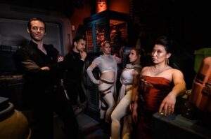Erika Ishii Instagram - May the 4th be with you! Last year, my crew and I booked passage on the Star Cruiser Halcyon. It was a transcendent immersive experience and immensely inspired me in my storytelling. Thank you @car0mur for introducing us to the colorful characters onboard, and to the cast and crew who made our stay unforgettable. My friends and I boarded with elaborate backstories and costumes and every person aboard met us at our level and helped us live out our dreams on a galaxy far, far away. ♥️

Meet the motley crew of the Arabesque, a humble merchant ship that can help acquire anything you need.  Our pilot always said, “She doesn’t look like much, but out there in the stars, she dances.” I was Captain Lane Vizla (I borrowed the name of the SWTOR character I voice!) Socialite and pulp holo-vid actor by day, and by night a scoundrel using social connections to aid the Resistance. I hand painted my gown with Aurabesh: JUSTICE, TRUTH, LOVE.

Also today I can announce another new credit in a Star War: I’m a friendly Scoundrel/Smuggler in LEGO Fortnite!