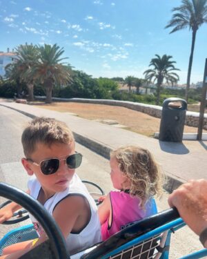 Helen Skelton Instagram - When the year old doesn’t get a shot at her own pram….. 
and the cute outfits I got for them are overlooked for a bargain bulk buy of last years Menorca merch…..
Just over here picking my battles.❤️😍🤪
#memories #summer #holidays