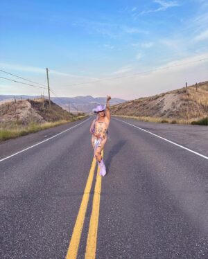 Ilona Verley Instagram - “You were a mirage, you’re not really there”
🐎🐎🐎🐎
Inspired by @slayyyter & the cowboys music video!
🐎🐎🐎🐎
This look was originally made for me a few years ago by @connormccalden who did up the chaps/ bra & gloves for me when I was in Toronto for a few months and running out of outfits at the time!
I later made the hat and the bodysuit to go with it & @hauszuk helped me stone everything! 
🐎🐎🐎🐎
I’m so happy to have finally gotten to shoot this look & to do it with my incredible mom @sandiverley who took off a whole weekend to drive us up home to the canyon and literally camp until it was cool enough for us to drive to the ghost town to actually shoot… our one day trip turned into a 3 day adventure!
THANK YOU MOM!
🐎🐎🐎🐎
Hair was done for me the MORNING of by @the.girlfriendexperience
Also a big shout out to sheisbliss for helping me stone and get myself together that morning as well!
Hat was originally from @rockin_cowboy_clothing_company painted and transformed by me! (Reel coming soon on the DIY) 
Boots were from @onlymaker_shoes transformed by sheisbliss & myself! 
Earrings by @sadndn_ 
🐎🐎🐎🐎
I used to try to be so independent and do everything myself, but the last little bit, I’ve been giving up the perfection complex of wanting to do it all alone & it has helped me see that creating is not only easier but much more rewarding when you work with others, especially the people you LOVE!
The funny thing is to me the most perfect art has been the stuff I’ve done with friends… not the stuff I’ve done alone… (learning lesson for those struggling with giving up control / dealing with the typical artist perfection complex) 
🐎🐎🐎🐎
#cowgirl #cowgirlfashion #cowboyhat #purple #lavenderhair #humanhairwig #drag #dragqueen #purplemakeup #onlymaker #festivalfashion #ravegirl #ravegirls