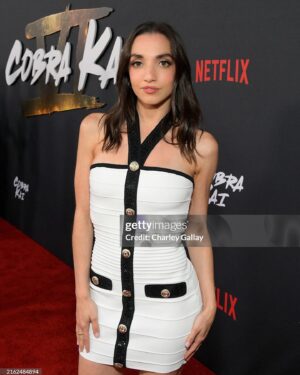 Julia Macchio Instagram - Cobra Kai is BACK, baby! 🤍🖤
It was such a joy getting to celebrate with the @cobrakaiseries fam at the LA premiere! 
The first 5 episodes of Season 6 are out on @netflix now! ❤️🥋🥹 

Hair cut & style: @neilweisberg @mechesalonla 
Makeup: me 
Dress: @retrofete