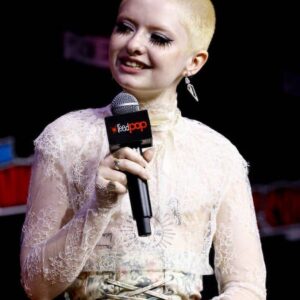 Lachlan Watson Instagram - I Got My Top Surgery At The Chucky New York Comic Con Panel (NOT CLICKBAIT!!!!) 😭😳

thank you massively to the @syfy team and daddy @realdonmancini for making this dream come true 

and thank you dearly to the muses at @shopdoramaar for understanding what i meant when i said lacy horror weirdo bondage♥︎ 

wearing: Bella Freud lace top from the closet of @lcmshops x @inkindmag
Zimmerman corset skirt from the closet of @taramoni_
photo by DoMa's @jancrlo 
#dressedindoma