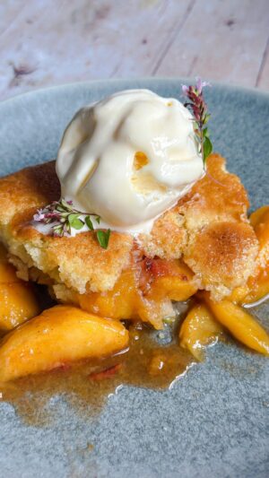 Laura Vitale Instagram - If you make anything this weekend (especially last minute) let it be this sensational peach cobbler! It’s simply the absolute BEST! Those of you that have been making it for years you always tell me it’s a summer staple for you and for good reason. It’s simple, yet the peaches shine, the batter is spongey and it’s a perfect partner to a good scoop of ice cream (if you dare to be extra naughty add a scoop of butter pecan to this and you’ll be in heaven) it’s out of this world! Recipe on my site (linked in bio) ❤️ 
Life changing tip from my nonna, to peel peaches, freeze them for about an hour then take them out, let them sit for like 15 min and you can peel them super easily! It works!