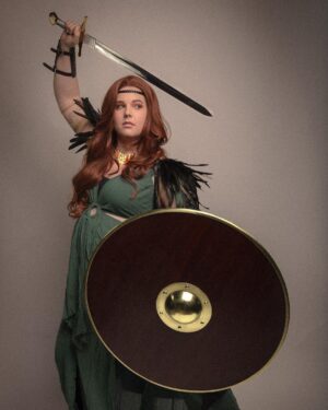 Lindsay Jones Instagram - The photos are in from my second maternity shoot and THEY’RE AWESOME! I wanted to pay homage to Freyja (Freya), Norse goddess of love, fertility, war and death, who is also a mother of two with Odr! Her colors are gold and green, which I implemented into the costume and body paint. Complete with her Brisingamen, feathered cape, sword and shield, she is ready to slay her enemies and her lovers. 
HUGE thank yous to @jonrisinger @texasdelarosa and @andy_blanchard for making this dream of mine a reality! Jon had the brilliant idea to use filters to give them a painted parchment feel. Instagram doesn’t even do these justice. I will be posting more! ❤️