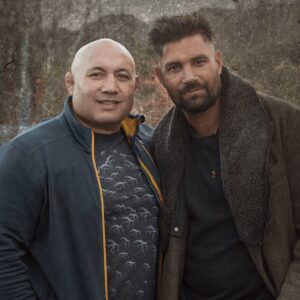Manu Bennett Instagram - Just heard the sad news that Norm Hewitt passed away. I attended Te Aute Maori Boys College with Norm & we had our differences but also our similarities. We managed to heal some hereditary wounds by participating in a documentary called Making Good Men which highlighted the violence we both endured growing up & battled with during our adult lives. It won best documentary at the NZFTV Awards & Peter Jackson let us hold a private screening for Te Aute students at his studio cinema in Wellington. Like many Maori of our generation, birthed from the Once Were Warriors generation, Norm fought to overcome the torments of a hard upbringing. He gave me a couple of serious hidings at Te Aute & had such a terrifying presence & drill sergeant mentality pushing us through the fog on the rugby oval for the Te Aute 1st XV training at 5am, I later used these memories to characterize the gladiator Crixus which I played in Spartacus & also Azog the giant Orc. I was actually on the way to film my final scene for the third Hobbit Movie, when I ran into Norm at Auckland Airport. He tapped me on the shoulder & when I heard “Manu”, I knew it was him, even after 20 years. He then proceeded to tell me how he & his son watched Arrow together & enjoyed my role as Slade Wilson. Norm & I shared the most precious hongi at that moment, the setting aside of anger & egos. He laid the foundation for forgiveness & healing a wound which I'd carried since meeting his fists at Te Aute. Yet over the years I was so proud to see him reach the All Blacks & especially proud when he won Dancing With The Stars infusing a haka into a tango that shook the nation. Legendary Norm Hewitt, you are etched into my memory as the strongest of Kahangunu toa (warriors) You set your sites upon the stars & landed on a lofty mountain. My sympathies to you Arlene & your tamariki Elizabeth & Alexander. Kua hinga te tōtara i Te Waonui-a-Tāne. Farewell Norm & thank you for everything brother.
