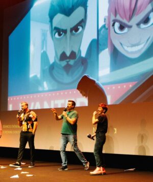 ND Stevenson Instagram - ANNECY JE T’AIME

Never could have imagined that this seven-year journey (or eleven-year journey, depending on how you want to count it) would lead to a standing ovation at Annecy and an honest-to-god medieval castle decked out in Nimona pink. Thank you Nick, Troy, Karen, Julie, and all the other TOTALLY METAL people who fought for this movie to exist. June 30…let’s break some stuff 🤘🦈💥💥💥