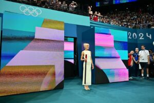 Nastia Liukin Instagram - What an incredible honor to have been asked to perform “Les Trois Coups”  last night at the Women’s Team Finals… Thank you so much @paris2024 🤍  It was truly the biggest honor. 

For those who aren’t familiar, “Les Trois Coups” is inspired by the tradition of French theater, to signify the start of a performance, that the show will begin shortly.. This local  tradition was carried over to the Olympics to open and being each competition and sport at the Paris 2024 Games. 

PS @johnkcheng with the ultimate framer of the night… without even realizing it in the moment – keep scrolling / zoom in far right to see my dad who happened to be trying to walk by at this exact moment to only be asked to please stop because someone was coming out of the tunnel - to then seeing me and mostly likely wondering what the heck I was doing walking into the arena of the olympic team final… in a DRESS lol