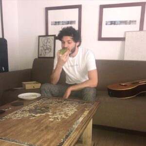 Nick Fink Instagram - Celebrating my birthday in these strange times with an avocado everything bagel, a much too difficult puzzle, my ‘it’s empty in here’ shirt, some nice pants, my guitar, the matrix on tv, my slow growing quarantine beard, and idk I’ll probably facetime the pugs later. Stay safe out (in) there everyone.❤️