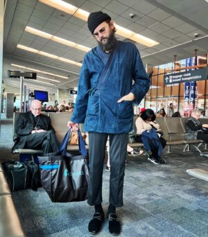 Nick Thune Instagram - BEST DRESSED AT THE AIRPORT 🥇
Felt good coming into the port today but got worried when I saw who I was up against. The priest took runner up like an absolute G and then nodded off for a quickie. #bestdressedattheairport #priesthood #catholiccreatives