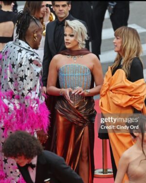 Nicky Doll Instagram - Yes we CANNES ✨

What an absolute pleasure to spend time in Cannes this year. Walking the red carpet with my two absolute icons, with whom we work relentlessly on this little show that does some real good in France and beyond 💅🏼 @daphneburki @kiddysmile we cleared. 

don’t forget to tune in for @dragrace_france season 3 May 31st! 🇫🇷💅🏼

Thank you @france.tv 🫶🏻

Wearing my icon @rochart_design sketched by @farida_kant 
HMU @juliencharlierparis 
Jewelry @gv.jewels_costumes 
Shoes @louboutinworld