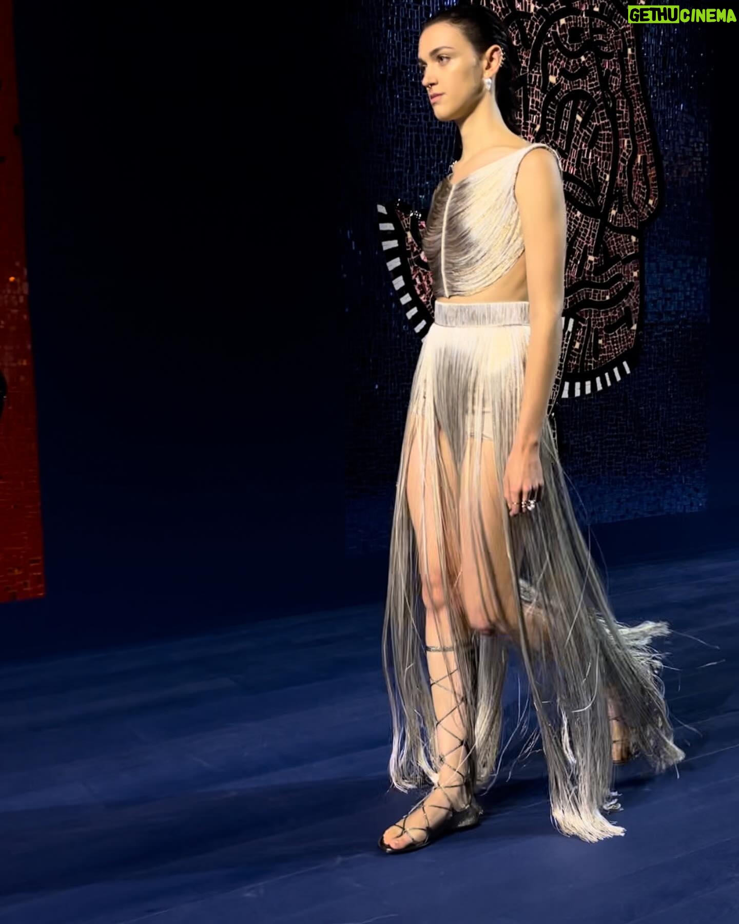 Rosamund Pike - 102.6K Likes - Exceptionally beautiful time at the Rodin museum watching the @dior Haute Couture show. Mirrored and embroidered wall panels by the late great Faith Ringgold depicted athletes in all disciplines and sports, providing counterpoint to the physiques of models draped and tailored in exquisite pleating, metallic jersey, feathers and ribboned fabric. Movement was an essential part of this show. And I have tried to capture bodies in motion. Architecture of the body celebrated by fine architecture of clothes. Maria Grazia has outdone herself today. A shining show!!! My hair and makeup done by @valeriaferreiramakeup and @davidebarbieri_