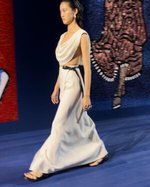 Rosamund Pike Instagram - Exceptionally beautiful time at the Rodin museum watching the @dior Haute Couture show. Mirrored and embroidered wall panels by the late great Faith Ringgold depicted athletes in all disciplines and sports, providing counterpoint to the physiques of models draped and tailored in exquisite pleating, metallic jersey, feathers and ribboned fabric. Movement was an essential part of this show. And I have tried to capture bodies in motion. Architecture of the body celebrated by fine architecture of clothes. Maria Grazia has outdone herself today. A shining show!!! My hair and makeup done by @valeriaferreiramakeup and @davidebarbieri_