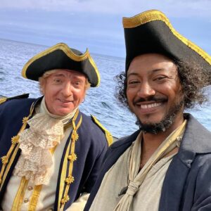 Samba Schutte Instagram - Crew Shoutout part 2: the first time I met @rhysiedarby at rehearsals he said hi and I said “I LOVE YOU”☠️ Never walked it back since. He worked so hard this season but always looked cool, always improvised effortlessly as Stede⚔️ That red suit WAS cursed- triggered the fire alarm as soon as he stepped on stage❤️‍🔥 And that mermaid tail was really heavy, but look how graceful!🏴‍☠️🧜‍♂️ 
#OurFlagMeansDeath #ofmd #ofmdseason2 #bts