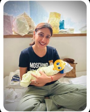 Surbhi Chandna Instagram - Beaming with Joy on getting promoted as a MAA-si 🪬🥹

So fortunate that this Little one could be a part of my wedding 🤣 when he was in PC Mammas Tummy

Thankyou for this happiness @pranavi_chandna and hats off to you for managing my work and taking on Maamma Duties with Panache 

My First time ever holding a tiny little being that explains the scared & emotional smile 😅 and hes the cuteestttt baby i have EVER seen 🧿 cant stop kissing his tiny fingers, little feet , small tummy 😍

Also learning how to swaddle , clean this little ones poopie 💩, and making him burp 🦧 
#sayhellotonewestmaasiintown