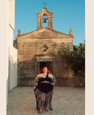 Tess Holliday Instagram - Y’all I have so much to say & so much to post about my trip in Italy with @stellavisiontravel 🥹 but in the meantime I’m trying to stay in the moment and soak it all in. You can get some sneak peeks on @stellavisiontravel & even if you don’t go on a  tour like this with them, have Zoe plan your private trip & go to my new favorite places like this farmhouse hotel outside of the ancient city of Matera to my new bestie 🫏 and pose in the sun outside an old chapel (no longer used for religious purposes)

@photosbyallegra is our tour photographer! (Every @stellavisiontravel tour has one!) 

#solofemaletraveler #effyourbeautystandards #womenwhotravel #plussizetravel #italy #femaleentrepreneurship #southitaly #matera
