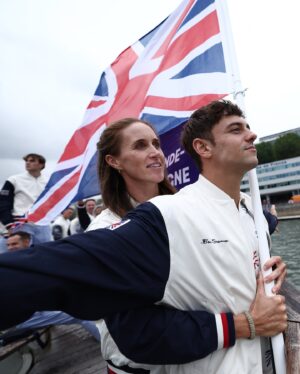 Tom Daley Instagram - 🇬🇧 TEAM GB FLAGBEARER 🇬🇧
•
•
Such an honour to be carrying the flag at the opening ceremony for Team GB with @helenglovergb ❤️🇬🇧 I made a little heart hand signal for my boys watching on TV! I am so excited to have them here to share this experience with me for my 5th games! Even if it was a little wet 💦 ☔️ #Olympics #Paris2024