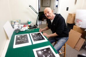 Tony Levin Instagram - It’s signing time for me. My new photo prints will go out in May, but I’m heading on the road soon, so need to get them signed now. Gotta love those Sakura pigma micron 05 pens.