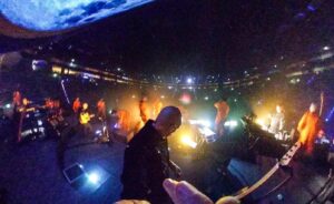 Tony Levin Instagram - This pic from last night in Cologne looks more like a horror movie than a show. Men in orange march towards me as the huge moon is about to collide with earth. #petergabriel