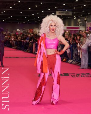 Trinity the Tuck Instagram - What an incredible weekend at @rupaulsdragcon UK! Thank you all who came to visit me at my booth! It was my pleasure to talk to each of you! Thank you to my team of Tuck Support who helped facilitate such a professional and easy work space! I’ll see you at the next one ! Hair by the incredible @baehmbaehmwigs suit embellished by @natalia_at_nite and the amazing blue jacket by @mr_riegillio . Jewels by @ampedaccessories . Photo credit by @stunnin.mag and @gettyimages