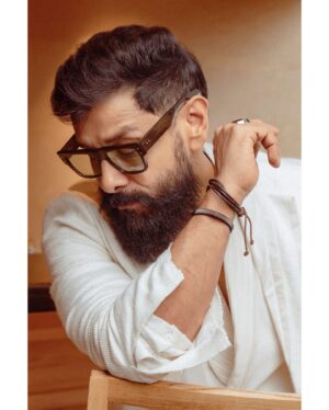 Vikram Instagram - In a world of colours, be the shining white.  Styled by @ishabhansali. 📸 @puchi.photography. Outfit @antar_agni_ujjawaldubey
Accessories @ishhaara 
Sunglasses @rosvinbugs 
Shoes @whitemuds_official #thangalaanfromaug15