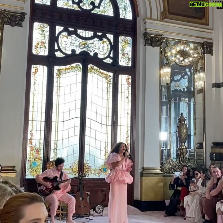 Assucena Assucena - 5.9K Likes - Fui presenteada com o convite de @paula_raia para construir junto com ela uma trilha para sua última coleção. O que eu não imaginava é que não era apenas mais um belo desfile ou mais uma coleção pensada minuciosamente ; mas uma imersão sensível nas memórias de Paula Raia para homenagear Dona Lina, sua mãe. A ideia era rememorar o quarto de vestir de Dona Lina, o qual foi território criativo e afetivo fundamental para que Paula desenvolvesse com maestria seu ofício. No primeiro encontro na casa da Paula, Jeff Ares ( @aresjeff )pega o roteiro e me pergunta: “Assu, traz pra gente uma canção angelical que te venha à cabeça?” E comecei a cantar “Estrela, Estrela”, canção lindíssima de Vítor Ramil, gravada por Gal no disco Fantasia na década de 80. Estava escolhida a canção de abertura de “Eu Palco - Meu Tempo no Mundo”. O repertório sugerido pela Paula e Renan ( @renanflumian ) já estava precioso com Óleo de Una Mujer de Sombrero, Love Calls You By Your Name e Mãe Menininha do Gantois, canção que a mãe da Paula cantava enquanto se arrumava . Fruta Gogoia foi uma sensível sugestão do @andrecezarmendes , canção que costurou e fechou o desfile. Para a missão de construir a trilha convocamos Rafael Acerbi ( @rafael.acerbi ) que foi essencial no processo, com seu violão, guitarra e base. Dito isso, quero agradecer com carinho ao @andrecezarmendes que foi quem primeiro me recebeu com o convite e também foi fundamental. Gratidão Jeff Ares pela ponte linda com a Paula. Gratidão Renan Flumian. Gratidão a toda a equipe da Paula que me recebeu sempre com muito carinho e profissionalismo. TMJ querida Paula Raia, minha gratidão, meu respeito e admiração por você 🙏🏽✨❤️
Você levantou um espetáculo; uma obra de arte no @theatromunicipal
Muito, muito obrigada!
Assu