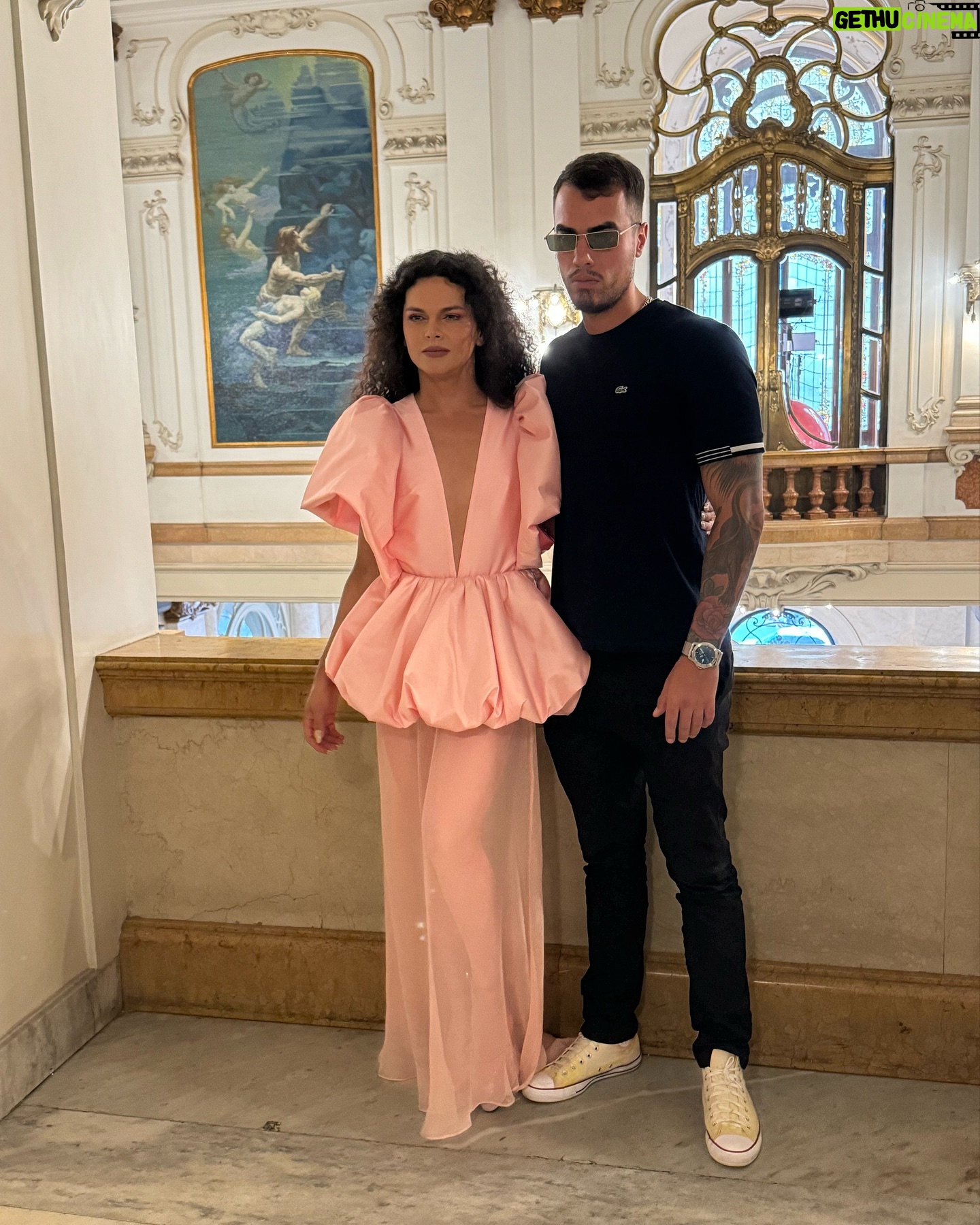Assucena Assucena - 5.9K Likes - Fui presenteada com o convite de @paula_raia para construir junto com ela uma trilha para sua última coleção. O que eu não imaginava é que não era apenas mais um belo desfile ou mais uma coleção pensada minuciosamente ; mas uma imersão sensível nas memórias de Paula Raia para homenagear Dona Lina, sua mãe. A ideia era rememorar o quarto de vestir de Dona Lina, o qual foi território criativo e afetivo fundamental para que Paula desenvolvesse com maestria seu ofício. No primeiro encontro na casa da Paula, Jeff Ares ( @aresjeff )pega o roteiro e me pergunta: “Assu, traz pra gente uma canção angelical que te venha à cabeça?” E comecei a cantar “Estrela, Estrela”, canção lindíssima de Vítor Ramil, gravada por Gal no disco Fantasia na década de 80. Estava escolhida a canção de abertura de “Eu Palco - Meu Tempo no Mundo”. O repertório sugerido pela Paula e Renan ( @renanflumian ) já estava precioso com Óleo de Una Mujer de Sombrero, Love Calls You By Your Name e Mãe Menininha do Gantois, canção que a mãe da Paula cantava enquanto se arrumava . Fruta Gogoia foi uma sensível sugestão do @andrecezarmendes , canção que costurou e fechou o desfile. Para a missão de construir a trilha convocamos Rafael Acerbi ( @rafael.acerbi ) que foi essencial no processo, com seu violão, guitarra e base. Dito isso, quero agradecer com carinho ao @andrecezarmendes que foi quem primeiro me recebeu com o convite e também foi fundamental. Gratidão Jeff Ares pela ponte linda com a Paula. Gratidão Renan Flumian. Gratidão a toda a equipe da Paula que me recebeu sempre com muito carinho e profissionalismo. TMJ querida Paula Raia, minha gratidão, meu respeito e admiração por você 🙏🏽✨❤️
Você levantou um espetáculo; uma obra de arte no @theatromunicipal
Muito, muito obrigada!
Assu