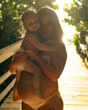 Bethany C. Meyers Instagram - Sharing the best photos I’ve ever taken in my entire life. Please enjoy round 1 from our maternity shoot. 

This is our little boardwalk to the beach. When we first moved to Florida in January, Kilmer was 10 months old. Each time we went to the beach, I would let her crawl down the boardwalk and think to myself, soon she’ll be running down this thing. 

I just so happened to get pregnant the same day we moved to Florida. And soon, she was running and I began to envision pregnant me walking with Kilmer down this path. And lately the visions have shifted to holding a newborn in one arm and Kilmer’s hand with the other while making our way to the ocean. 

This little boardwalk has become a special place. Big blue crabs often hide in earth surrounding us. We’ve seen snakes and birds and all kinds of critters that have made it a fun stop. It’s the shade from the sun, the place we swat mosquitoes and the spot where we strip down and wash the sand off our body while playing in the hose water. 

I wanted pictures with her here so badly and @createanomaly made that dream come true. I’ll always think fondly on these special moments together. Life before two. Just me and my first in barefoot exploration.