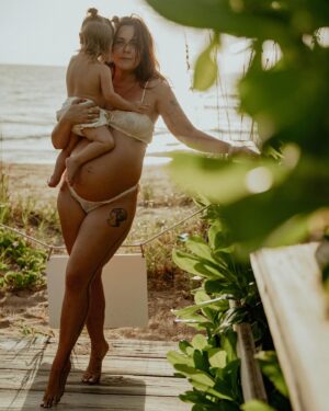Bethany C. Meyers Instagram - Sharing the best photos I’ve ever taken in my entire life. Please enjoy round 1 from our maternity shoot. 

This is our little boardwalk to the beach. When we first moved to Florida in January, Kilmer was 10 months old. Each time we went to the beach, I would let her crawl down the boardwalk and think to myself, soon she’ll be running down this thing. 

I just so happened to get pregnant the same day we moved to Florida. And soon, she was running and I began to envision pregnant me walking with Kilmer down this path. And lately the visions have shifted to holding a newborn in one arm and Kilmer’s hand with the other while making our way to the ocean. 

This little boardwalk has become a special place. Big blue crabs often hide in earth surrounding us. We’ve seen snakes and birds and all kinds of critters that have made it a fun stop. It’s the shade from the sun, the place we swat mosquitoes and the spot where we strip down and wash the sand off our body while playing in the hose water. 

I wanted pictures with her here so badly and @createanomaly made that dream come true. I’ll always think fondly on these special moments together. Life before two. Just me and my first in barefoot exploration.