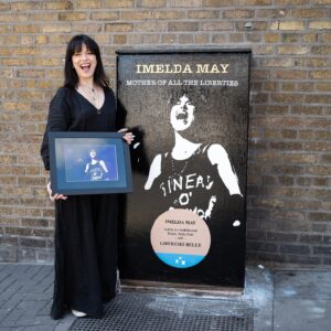 Imelda May Instagram - I’m so honoured to be recognised by Dublin Canvas in celebrating the living…! Thank you so much! 

Steve O’Toole (@urnique.steve ) the artist who started this initiative explains…

“Ireland is very good at commemorating & remembering our dead but we do little to celebrate our living. There are blue plaques all over Dublin to remember and mark how ‘Oscar was born here, Behan drank there, Joyce etc. and only in death Sinead, Shane and many many more are justly & rightly celebrated but whom in life were never given the accreditation they so rightly deserved. 

And so my Dublin Canvas submissions began last summer with  ‘Pat Ingoldsby’s … Welcome To His Head … Complete with ‘Not Dead Yet’ Blue Plaque. 

Continuing this year with ’Imelda May … Mother of all the liberties… With accompanying ‘Liberties Belle’ Blue Plaque. 

* Mother of all the Liberties - A nod to the hierarchy & history of the women of the Liberties, and to Imelda’s current role in MOATB. 
* Liberties Belle - Reflecting on both ‘The proudly born Liberties Imelda’ and to Imelda’s own wonderful piece ‘Liberty Belle’.  

On seeing Imelda’s reposting of Celia’s ‘Highly Commended’ in the Arts & Entertainment category at the British Press Photographer of The Year Awards, and Imelda’s accompanying copy …
‘This photo of me from Cambridge Folk Festival last summer. Sinéad had just gone. I painted my top impulsively Put on my mother’s chain, my Jeff Beck pendant. Walked onstage with my band and sang with all my heart. Emotional night captured. Friendship forever’. 
I knew instantly this was the only image to use. 

I cannot emphasise the outpouring of Liberty love & fondness for both Imelda and her family that has not only been expressed to me but also in turn extended to me by association. I am really going to miss working on this much loved piece.”

📸 on Meath St also by @ailecphoto

@dublincanvas 

#ImeldaMay 
#TheLiberties #TheLibertiesFestival #TheLibertiesDublin 
#DublinCanvas #DublinCanvasProject #DublinCityCouncil 
#ThisIsDublin #DublinEvents #Dublin8 #Dublin #Ireland