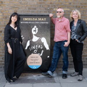 Imelda May Instagram - I’m so honoured to be recognised by Dublin Canvas in celebrating the living…! Thank you so much! 

Steve O’Toole (@urnique.steve ) the artist who started this initiative explains…

“Ireland is very good at commemorating & remembering our dead but we do little to celebrate our living. There are blue plaques all over Dublin to remember and mark how ‘Oscar was born here, Behan drank there, Joyce etc. and only in death Sinead, Shane and many many more are justly & rightly celebrated but whom in life were never given the accreditation they so rightly deserved. 

And so my Dublin Canvas submissions began last summer with  ‘Pat Ingoldsby’s … Welcome To His Head … Complete with ‘Not Dead Yet’ Blue Plaque. 

Continuing this year with ’Imelda May … Mother of all the liberties… With accompanying ‘Liberties Belle’ Blue Plaque. 

* Mother of all the Liberties - A nod to the hierarchy & history of the women of the Liberties, and to Imelda’s current role in MOATB. 
* Liberties Belle - Reflecting on both ‘The proudly born Liberties Imelda’ and to Imelda’s own wonderful piece ‘Liberty Belle’.  

On seeing Imelda’s reposting of Celia’s ‘Highly Commended’ in the Arts & Entertainment category at the British Press Photographer of The Year Awards, and Imelda’s accompanying copy …
‘This photo of me from Cambridge Folk Festival last summer. Sinéad had just gone. I painted my top impulsively Put on my mother’s chain, my Jeff Beck pendant. Walked onstage with my band and sang with all my heart. Emotional night captured. Friendship forever’. 
I knew instantly this was the only image to use. 

I cannot emphasise the outpouring of Liberty love & fondness for both Imelda and her family that has not only been expressed to me but also in turn extended to me by association. I am really going to miss working on this much loved piece.”

📸 on Meath St also by @ailecphoto

@dublincanvas 

#ImeldaMay 
#TheLiberties #TheLibertiesFestival #TheLibertiesDublin 
#DublinCanvas #DublinCanvasProject #DublinCityCouncil 
#ThisIsDublin #DublinEvents #Dublin8 #Dublin #Ireland
