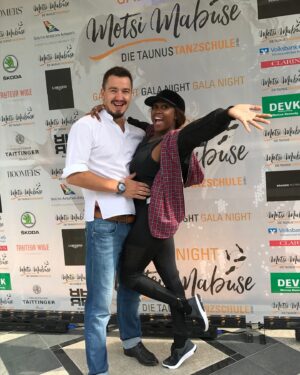 Motsi Mabuse Instagram - This story is worth the read lol 😝 and has a  happy end ❤️❤️❤️❤️ 
Now, seven years later, we stand on the brink of celebrating our  incredible journey. Our dance school has become a beacon of hope, a place where dreams are nurtured, and where the joy of dance is shared with everyone who walks through the doors. Against all odds, we  have not only built a successful business, but we’ve also created a home in a foreign land—a place where we belong.

Our story is a testament to the power of resilience, love, and unwavering belief in each other. It’s a reminder that no matter where you come from, or how difficult the road may seem, dreams can come true. It may come at a cost, and there will be sacrifices along the way, but when you face the journey together, those sacrifices are worth it.

As we prepare to celebrate their 7th anniversary @motsimabuse_taunustanzschule this Saturday, we want to share our story with others. We want to remind everyone —especially those who feel like outsiders—that you should never let anything or anyone demoralize you. Keep reaching for your goals, hold onto your dreams, and remember that together, anything is possible.

And now, we invite you to come celebrate with us tomorrow as we mark this special occasion—seven years of dreams realized, of challenges overcome, and of a community built with love and passion. Join us for free workshops, live acts, and a day filled with joy and dance. Let’s celebrate together!

#7YearsStrong #DanceJourney #CelebrateWithUs #DreamsComeTrue #TogetherWeAchieve #DanceSchoolAnniversary #FreeWorkshops #LiveActs #ResilienceAndPassion #FromDreamToReality #DancingAgainstAllOdds #CommunityAndDance #InspirationThroughDance