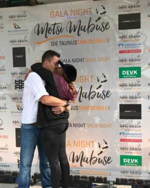 Motsi Mabuse Instagram - This story is worth the read lol 😝 and has a  happy end ❤️❤️❤️❤️ 
Now, seven years later, we stand on the brink of celebrating our  incredible journey. Our dance school has become a beacon of hope, a place where dreams are nurtured, and where the joy of dance is shared with everyone who walks through the doors. Against all odds, we  have not only built a successful business, but we’ve also created a home in a foreign land—a place where we belong.

Our story is a testament to the power of resilience, love, and unwavering belief in each other. It’s a reminder that no matter where you come from, or how difficult the road may seem, dreams can come true. It may come at a cost, and there will be sacrifices along the way, but when you face the journey together, those sacrifices are worth it.

As we prepare to celebrate their 7th anniversary @motsimabuse_taunustanzschule this Saturday, we want to share our story with others. We want to remind everyone —especially those who feel like outsiders—that you should never let anything or anyone demoralize you. Keep reaching for your goals, hold onto your dreams, and remember that together, anything is possible.

And now, we invite you to come celebrate with us tomorrow as we mark this special occasion—seven years of dreams realized, of challenges overcome, and of a community built with love and passion. Join us for free workshops, live acts, and a day filled with joy and dance. Let’s celebrate together!

#7YearsStrong #DanceJourney #CelebrateWithUs #DreamsComeTrue #TogetherWeAchieve #DanceSchoolAnniversary #FreeWorkshops #LiveActs #ResilienceAndPassion #FromDreamToReality #DancingAgainstAllOdds #CommunityAndDance #InspirationThroughDance