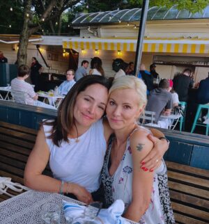 Sarma Melngailis Instagram - August: dinner by the water with the beautiful human @sarahedmondson from @alittlebitculty who managed to make a fanny pack cool? Non alcoholic cucumber drink. Books I read and appreciated. (laughter in the dark is harrowing in a way yet fascinating if you study sociopathy). Day trip to NJ, my first time leaving the state since I moved back. Considering my hair, a 🍌 colored helmet. I like it better with roots. Full moon. Excited for sweater weather and sweating less. 
Still ❤️‍🩹ing. 🐾

It’s time for changes. 
I love you ❤️