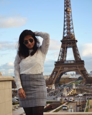Mithra Kasthurirangan Instagram - Photoshoot that manifested 🤩 In front of the Eiffel Tower. Truly surreal! Making it to the city of love, hot chocolate, croissants, and fashion 🖤 Though Paris has its own dark side, this shoot was a dream come true—a gift to myself I’ll always cherish.

Ootd details 
Skirt - @hm 
Top - @styleunion.in 
Shoes - @aldo_shoes 
Parka - @zara 
Stockings - From airport duty free