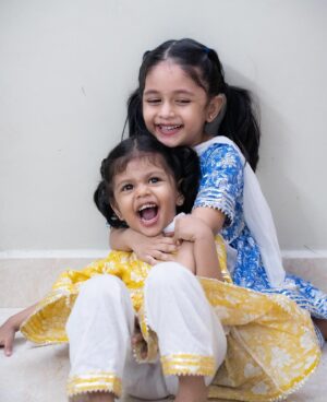 Zara Zyanna Instagram - Can’t contain the cuteness! 🥹♥️
They can do everything! 😂🥹♥️

Explaining the picture series slide to slide:
So they were dolled up for a gollu visit and we chose the twinning combo. Ziva loved the outfit as you can see anything that’s cotton and comfortable adds a smile to her face. Told them to pose for a picture and there you go 
SLIDE 1 Happy pose. 
And Zara really wanted a kiss from her baby sister and that’s the cue. Going down to her is a cue for Ziva to kiss. Hence the 
SLIDE 2 Kiss me cue pose. 
Once the little one got the cue. There you go! 
SLIDE 3 Kissy pose. 
After the kiss they started to play around and walked out of the frame and so the momma said stay in place for the picture. And that’s what they did. Worrying the momma with the Sad face. 
SLIDE 4 Samathhu pose 
and the last one.. couldn’t hold on the drama longer! They both fell over laughing 😂🤣 
SLIDE 5 Candid love pose. 

Which slide/pose is your favourite? 

Outfit: @kidcetra 
Shot by: @praveen.jpeg dada 🥹♥️