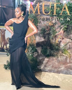 Anika Noni Rose Instagram - The way my team showed out on this @disney #Mufasa press tour has been thoroughly disrespectful.

Before I post ‘beauty shots’, I want to give a moment for this carpet situation. Because it was 32F, and that wind chill was not kind at all, but this looooook?!?! @ashistudio  brought the heat. 

Thank you, @ashistudio for draping me down for this London premiere. You knew only Queen attire would do.

Styled @jasonrembert 
Asst @thestylistguy 
Gown @ashistudio 
Shoes @louboutinworld 
Earrings 

Face @paintedbyesther 
Hair @seraiahartistry 
Color @ryanburrellhair 
 

#mufasa #lionking #milele #afia #fashion #ashistudio  #disney #littleblackdress🧡🦁