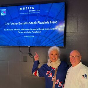 Anne Burrell Instagram - Soooooooo HIIIIIIIIIIIII everyone and Happy New Year!!! It’s been a minute since I have posted but I’m back!! An absolutely TREMENDOUS night last night @thegarden cheering on MY @nyrangers for a win and hanging out in the Delta Lounge and serving my Steak Pizzaiola Hero !! It was YUMMY!!! Getting to go on the ice was a HUUUUUGE highlight too!!! Oh what a night!!!! #theclaxtons #ilovewhatido #luckygirl